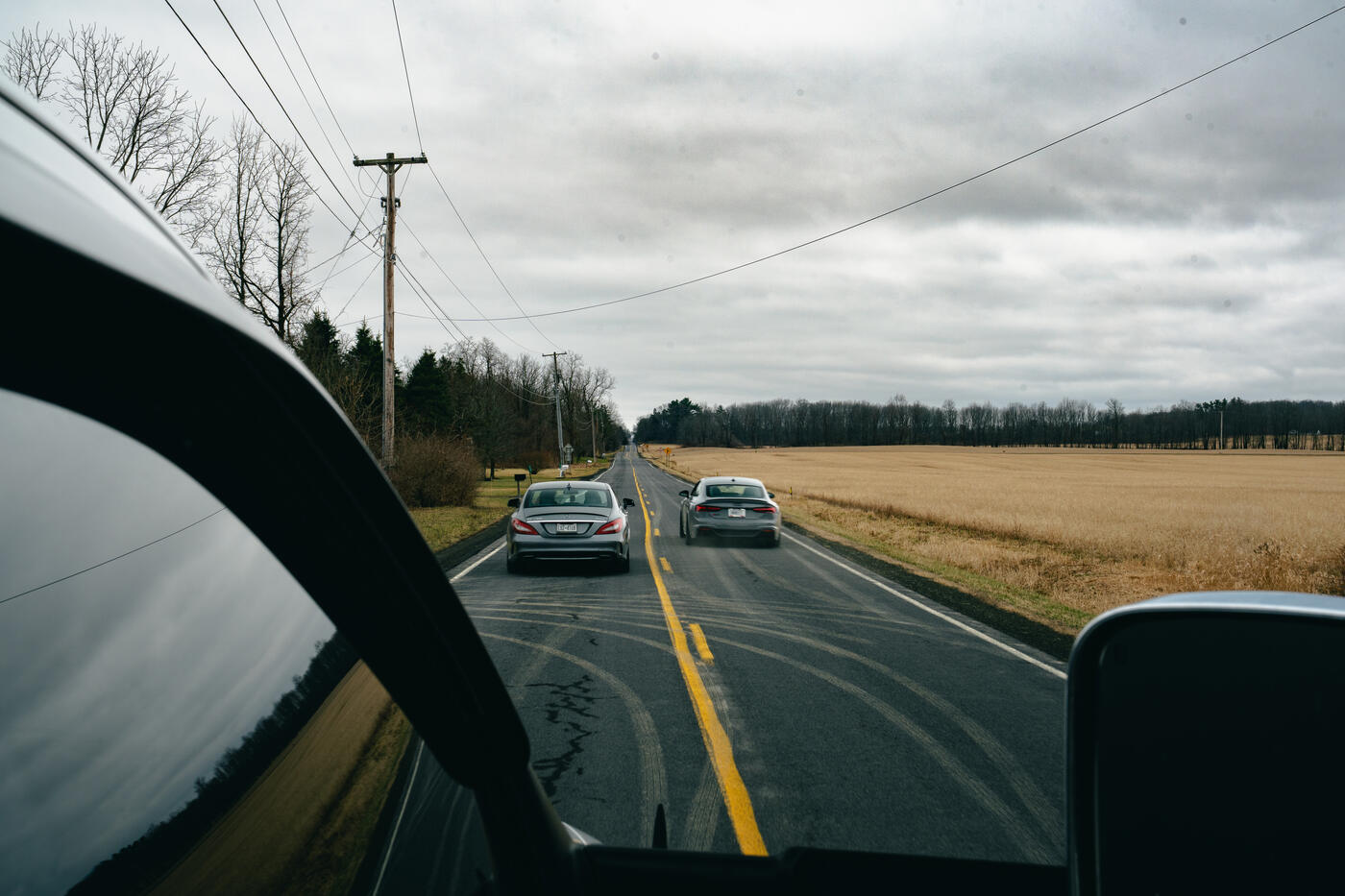 A convoy of club cars on a winding road