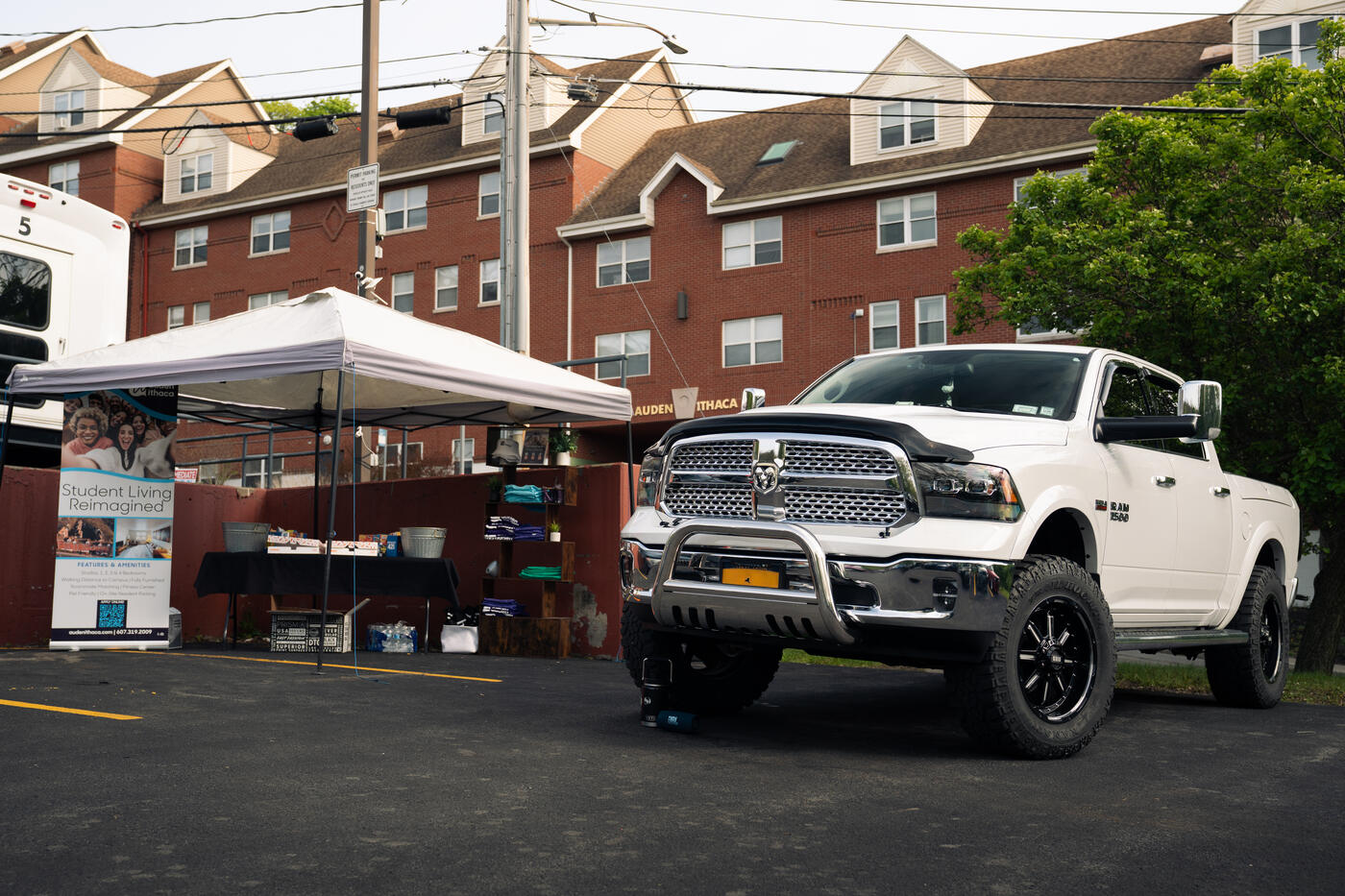 Club setup at the End of Year Meet with a lifted white Ram parked alongside