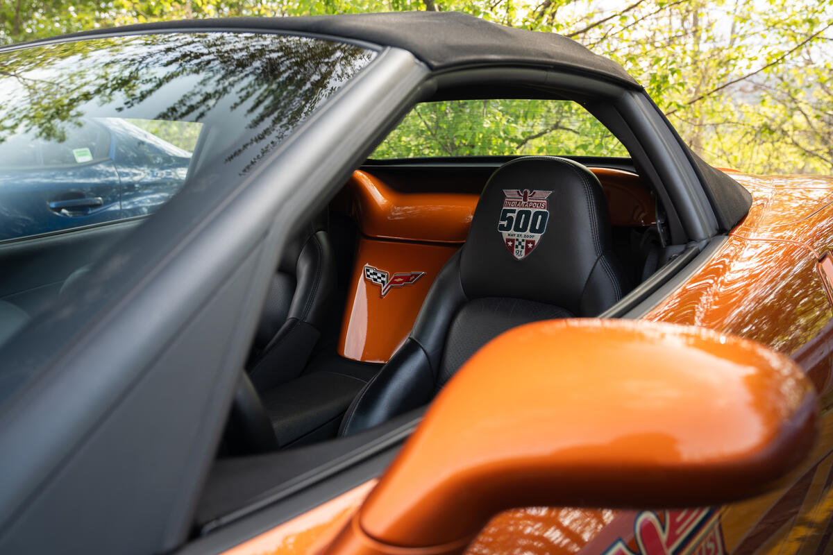 An orange Corvette at the meet